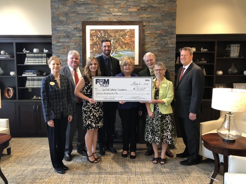 Bank staff presents check to SpiriTrust officials