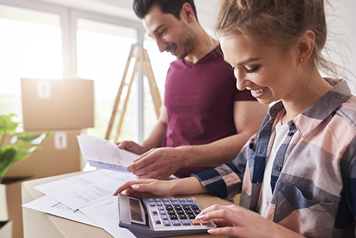 man and woman using calculator