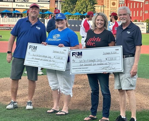 F&M Trust President and CEO Tim Henry and Franklin Financial Services Corporation Board Chairman G. Warren Elliott presenting $2,500 checks to Boys & Girls Club of Washington County CEO Addie Nardi and Girls Inc. of Washington County Executive Director Maureen Grove.